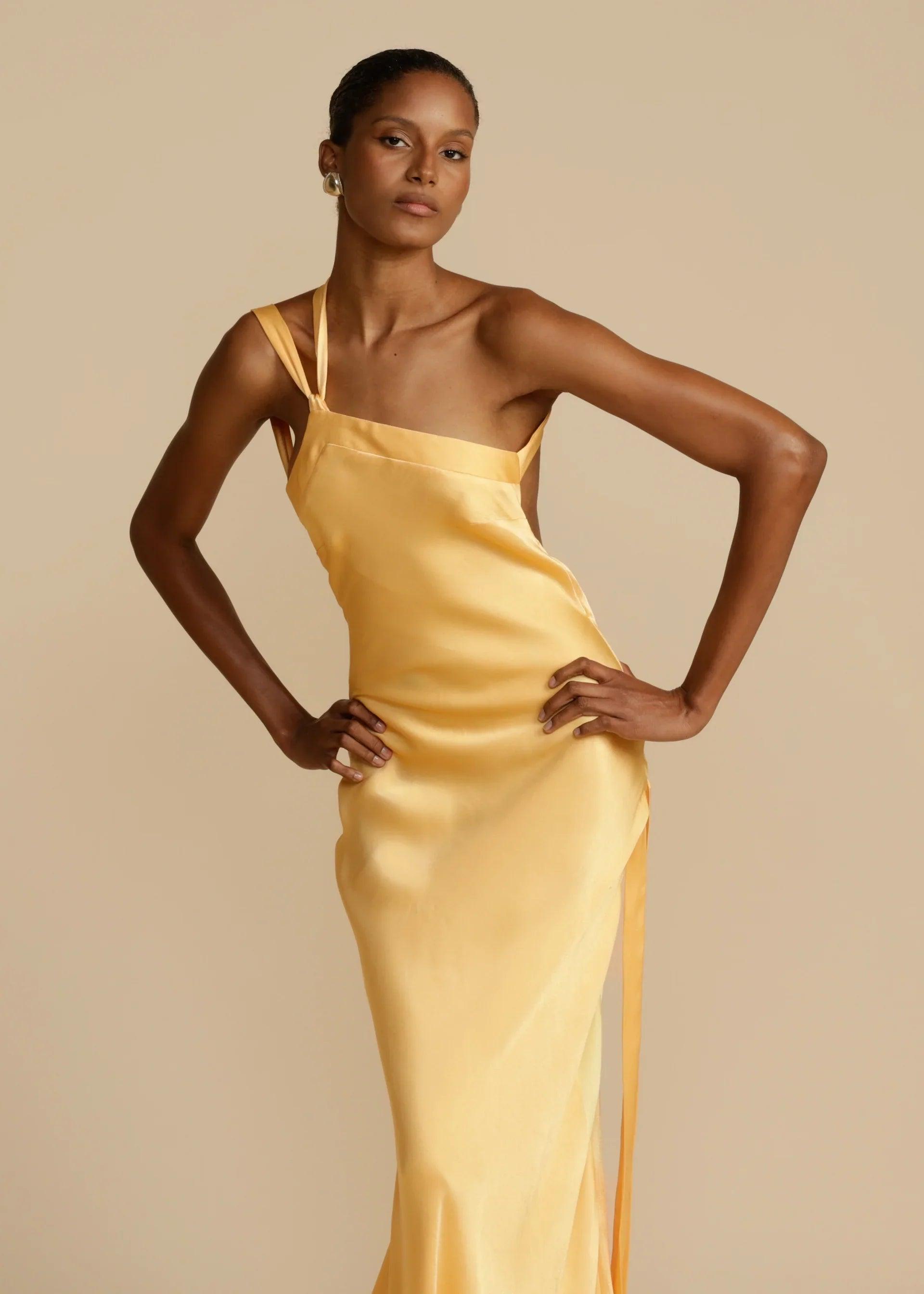 Vestido Longo Aurelia em satin jacquard amarelo com decote assimétrico e costas abertas, ideal para eventos sofisticados. Majestique.3